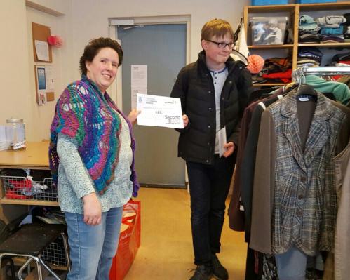 Leerling de Ambelt overhandigt cheque aan Stichting Kledingbank Deventer